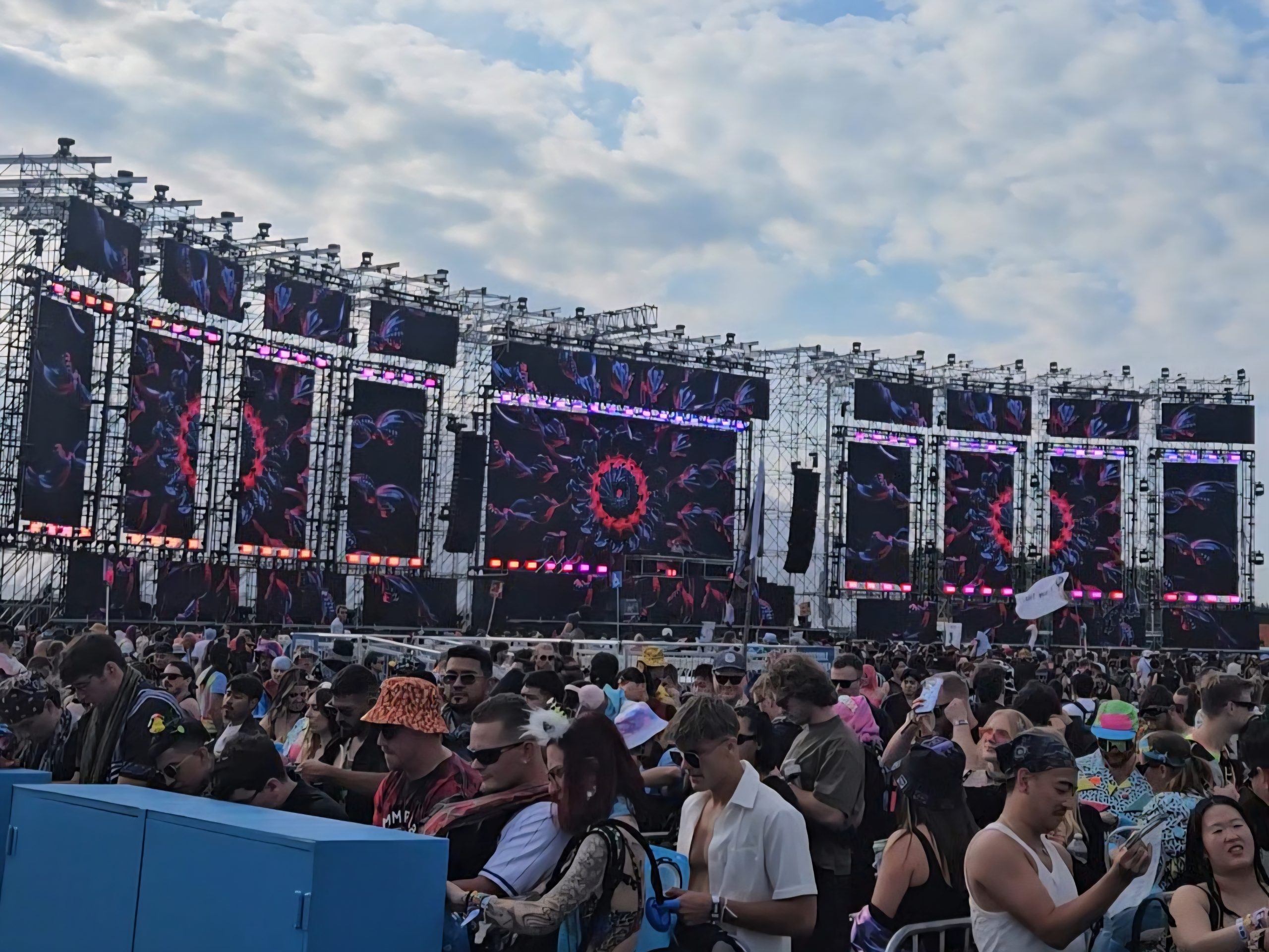 A large stage setup showing massive speakers and screens