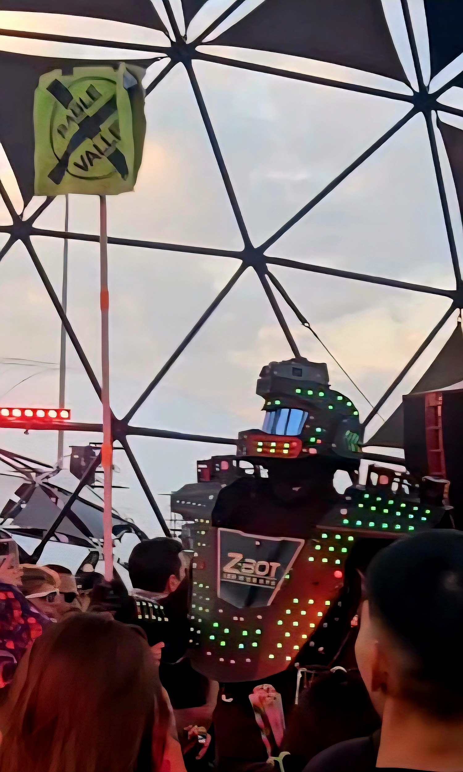 A Robot-Like Creature Joins the Crowd, Holding a Sable Valley Totem in The Fire Pit